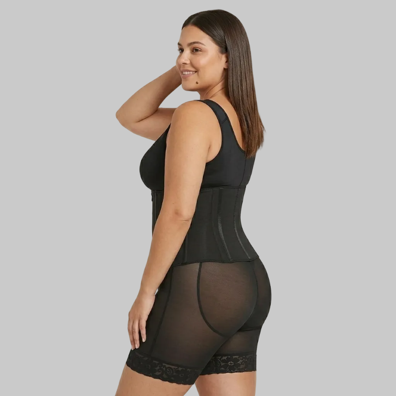Woman wearing a black shapewear garment on a beige background