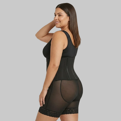 Woman wearing a black shapewear garment on a beige background