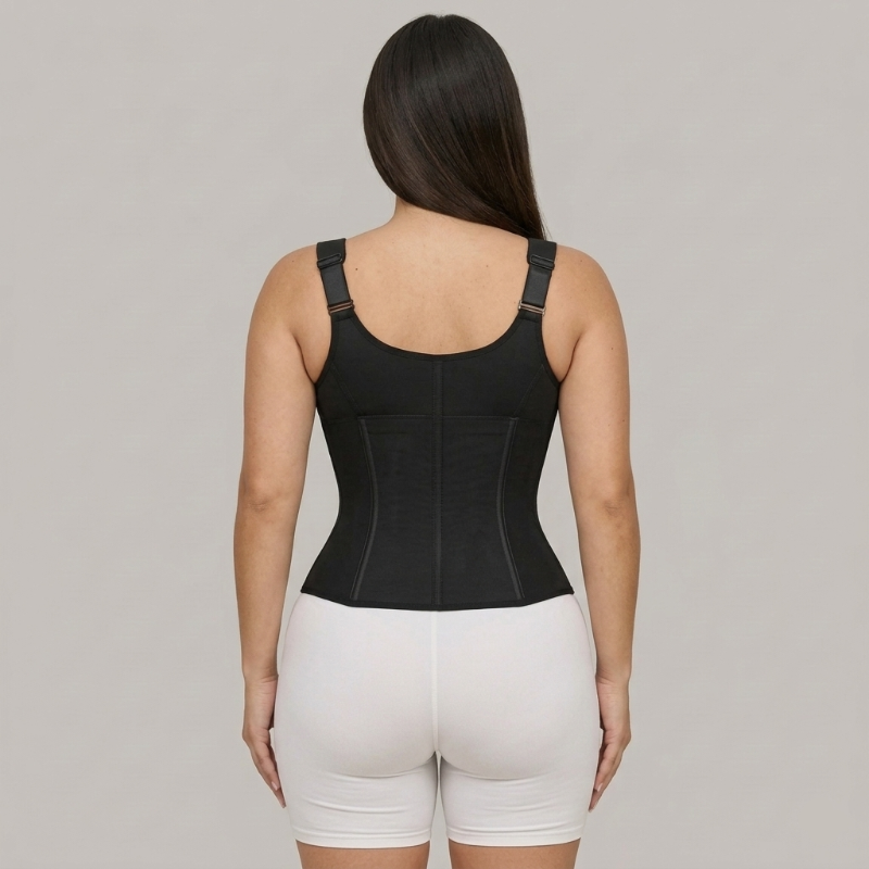 Person wearing a black compression garment on a gray background
