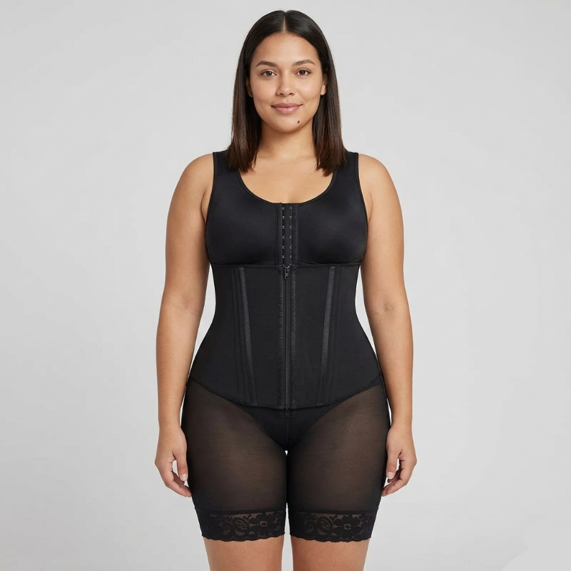 Woman wearing a black waist trainer against a gray background