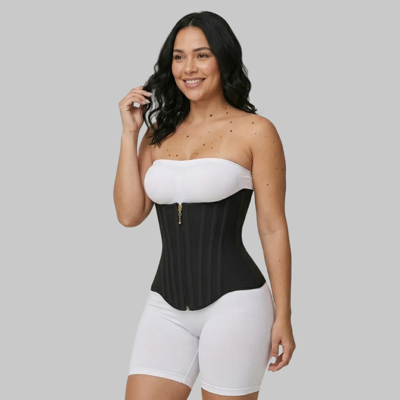Woman wearing a black and white waist trainer against a beige background