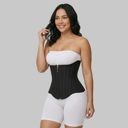 Woman wearing a black and white waist trainer against a beige background