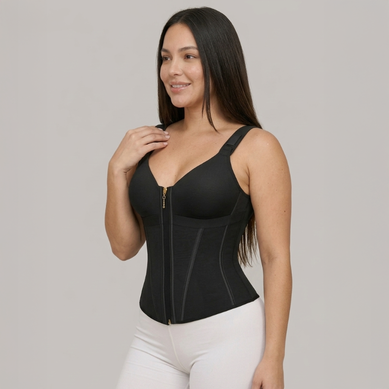 Woman wearing a black compression garment against a gray background
