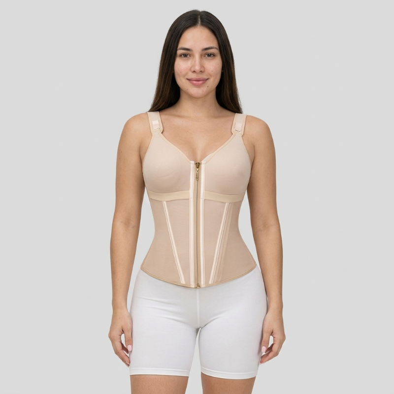 Woman wearing a beige compression garment on a gray background