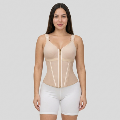 Woman wearing a beige compression garment on a gray background