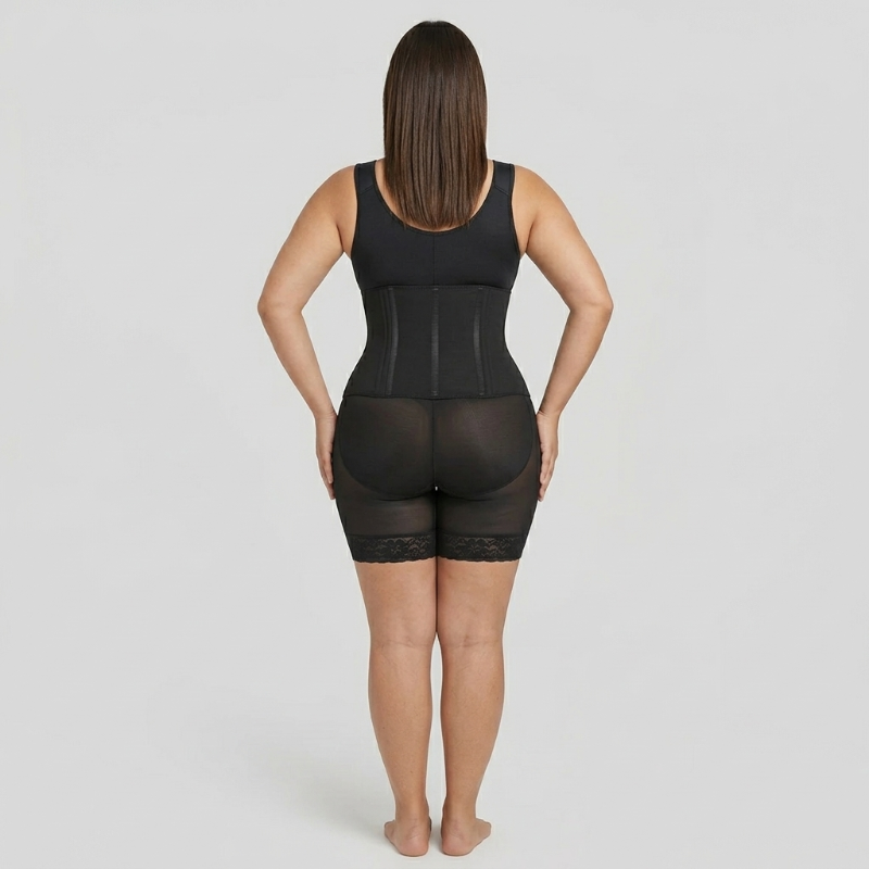 Person wearing a black shapewear garment on a plain background